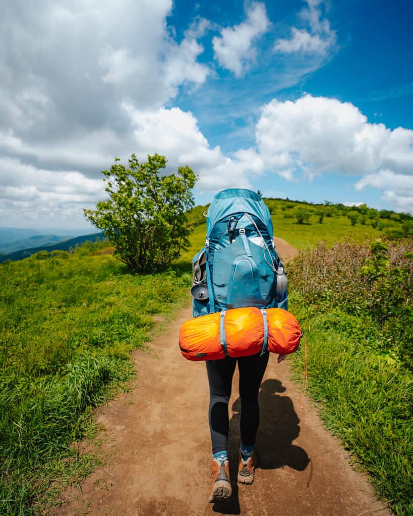 Woman backpacker in action on the trail at Roan Highlands TN