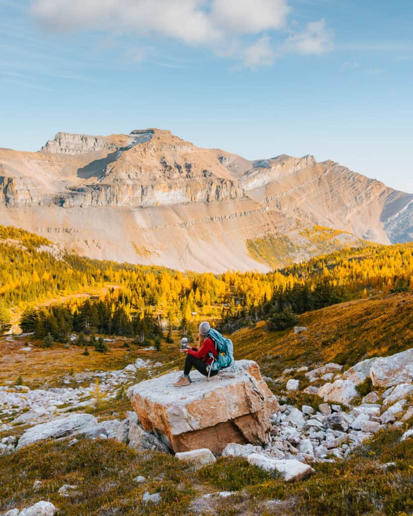 woman backpacker taking a break while backpacking the Canadian Rockies